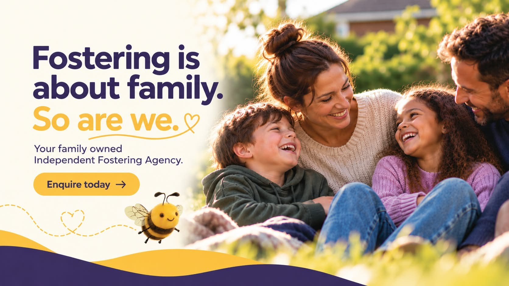 Two smiling adults and two children sitting together outdoors.